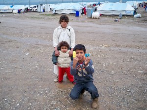 Children making finger puppits with sad and friendly faces they could use to tell their stories